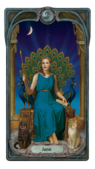 Character representing the goddess Juno sits on a peacock throne in a blue gown, holding a staff and a scroll. Two cats sit at her feet.